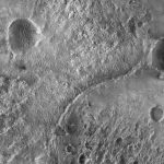 rover tracks across the dusty red surface of Mars