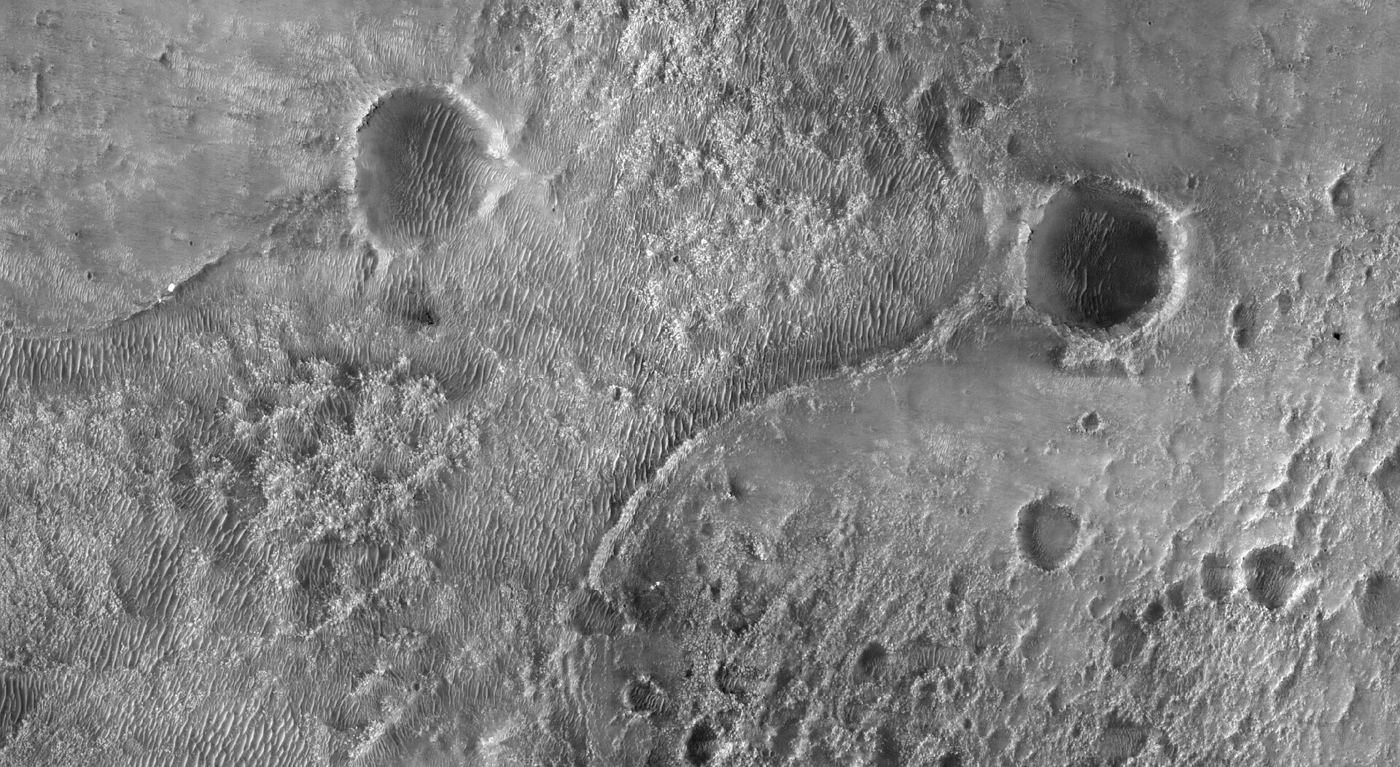 rover tracks across the dusty red surface of Mars